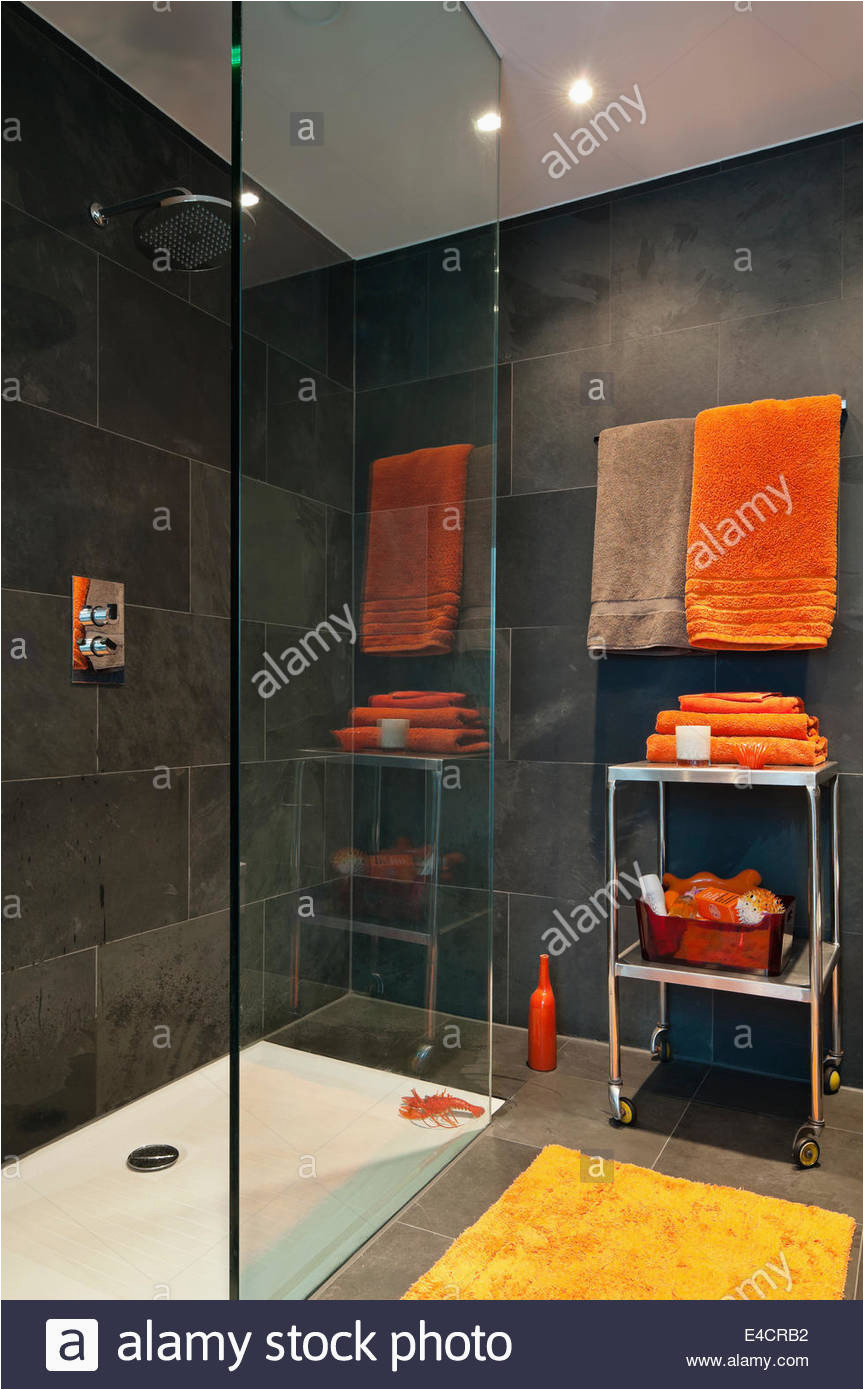 Bright orange Bath Rugs Bright orange towels In Bathroom with Slate Tiles Stock