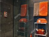 Orange Bathroom Rugs and towels Bright orange towels In Bathroom with Slate Tiles Stock